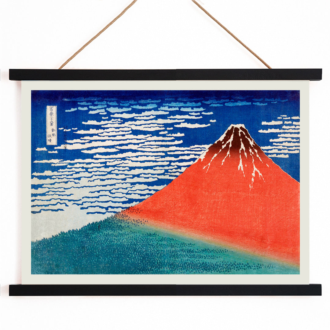 Fine Wind Clear Morning by Katsushika Hokusai poster showing red Mount Fuji under blue sky with white clouds, with wooden magnetic frame on white background