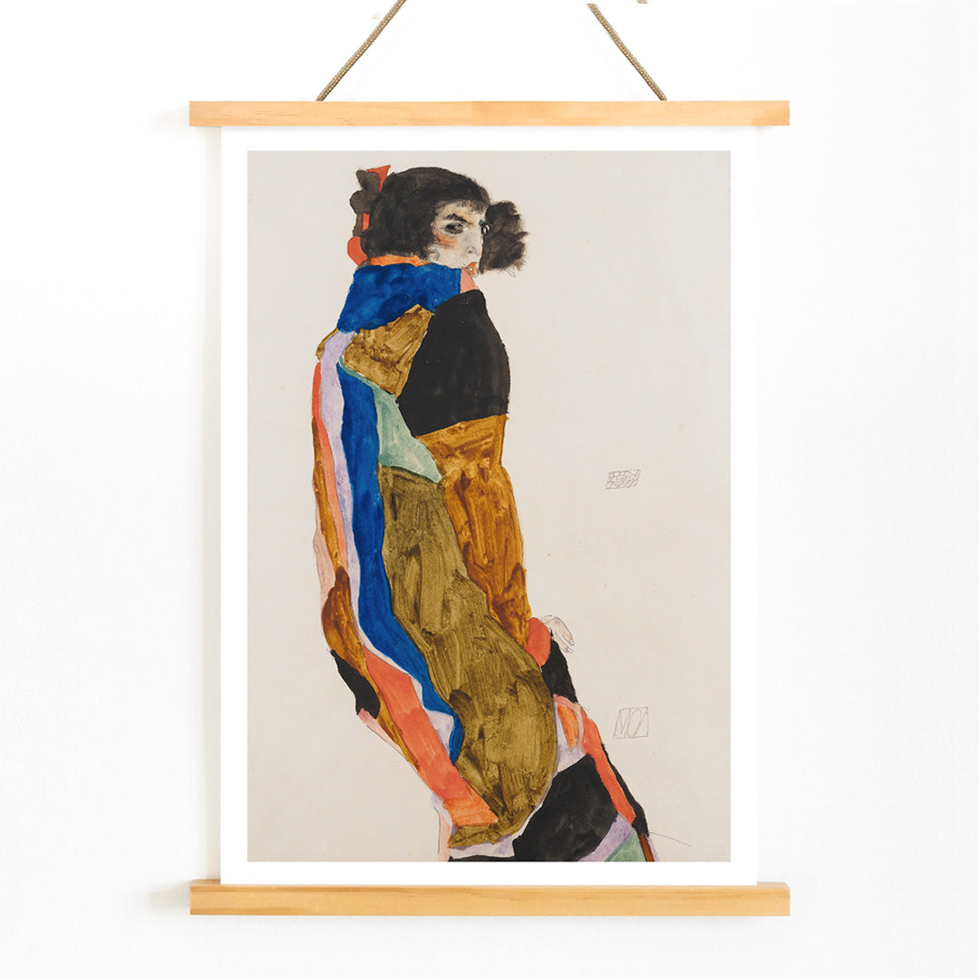 Colorful portrait poster of a woman in a patterned robe looking back Moa by Egon Schiele expressive art print, with wooden magnetic frame on white background