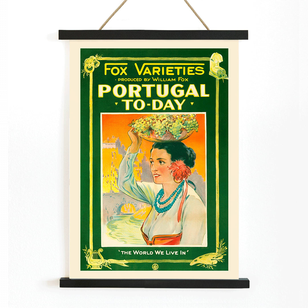 Colorful vintage poster of Portugal Today featuring a woman in traditional attire carrying grapes and fruit on her head with vibrant backdrop by William Fox and Anonymous, with wooden magnetic frame on white background