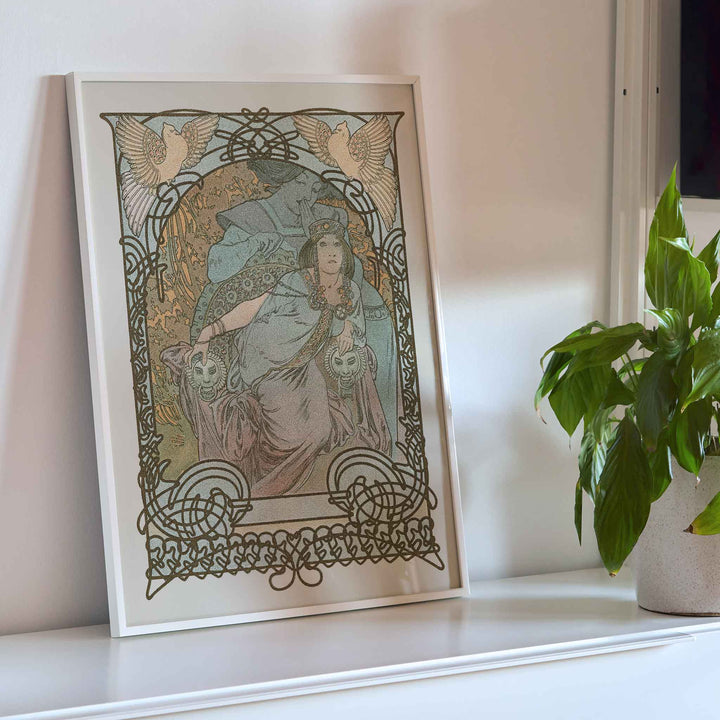 Alphonse Mucha Ilsee Princesse de Tripoli poster with elegant woman in flowing robes ornate floral lines and soft pastel tones, framed and displayed in modern living room decor