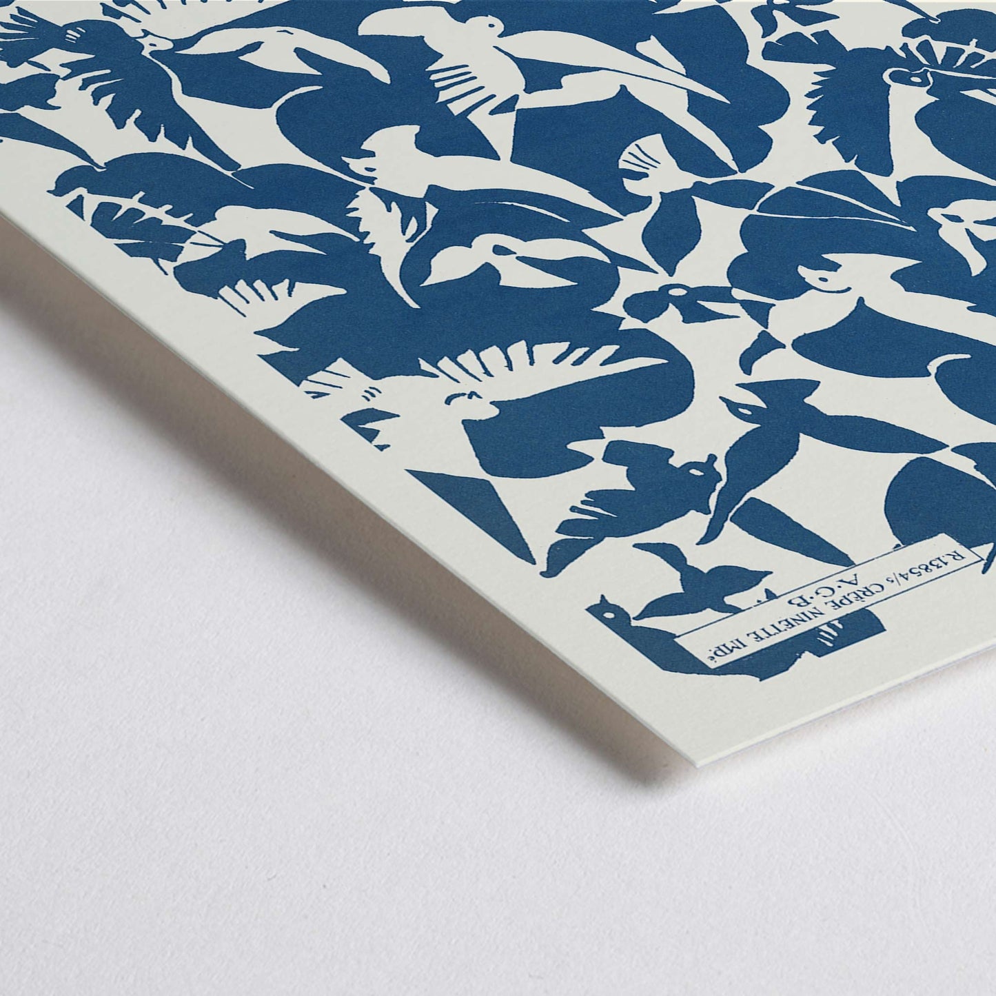 Closeup detail of Charles Goy Lesbesse crepe poster with stylized birds in bold blue and cream minimalist design