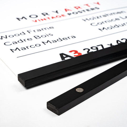 Black Pine magnetic wood frame with two sleek wooden bars and a simple rope for hanging, displaying a poster on a wall in a modern, elegant setting, back corner closeup picture