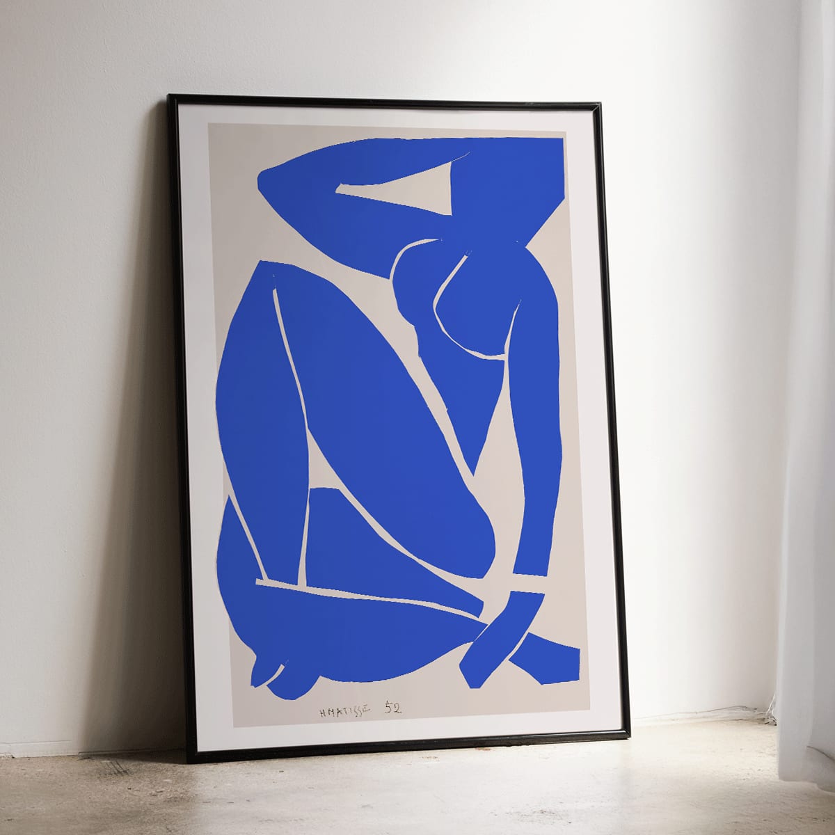 Nu Bleu III by Henri Matisse abstract blue figure on white background minimalist art poster, framed and displayed in home decor