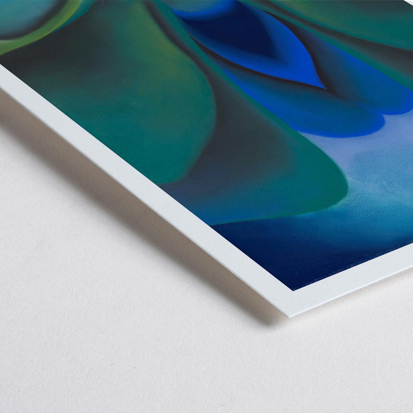 Closeup detail of Georgia OKeeffe Blue Flower poster luminous blue and green abstract bloom with soft yellow center