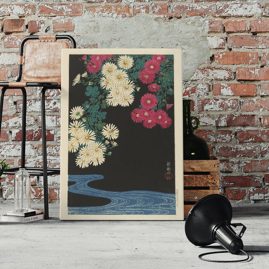 Chrysanthemums and Running Water by Ohara Koson Japanese art poster with yellow and pink flowers over blue water on black background, framed and displayed in home decor