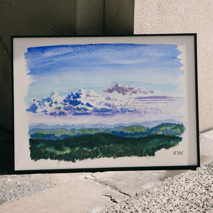 Watercolor landscape painting and abstract poster of blue sky and forest by Karl Wiener titled Naturstudie XXVII, framed and displayed in modern living room decor