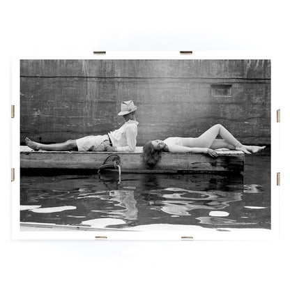 Marquess of Tavistock Henry Robin Ian Russell and Henrietta Tiarks relaxing on a dock in Bermuda by Toni Frissell poster, framed and displayed in modern living room decor