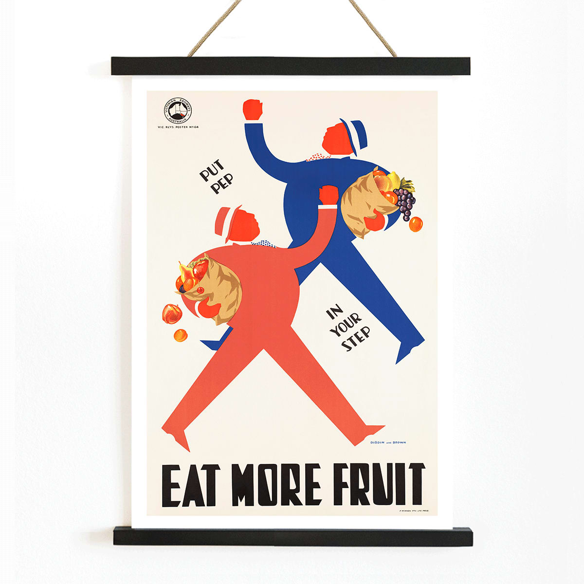 Colorful WPA Health Department illustration and poster promoting fruit consumption with stylized figures carrying baskets and the message Eat More Fruit, with wooden magnetic frame on white background