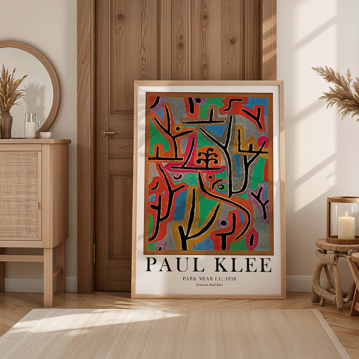 Exhibition poster of Park Near Lu by Paul Klee featuring vibrant abstract shapes and bold lines in diverse colors, framed and displayed in modern living room decor
