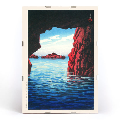 Kojaku Cavern Oga Peninsula sea cave with blue water and red cliffs vibrant sea cliffs and water by Kawase Hasui, framed and displayed in modern living room decor