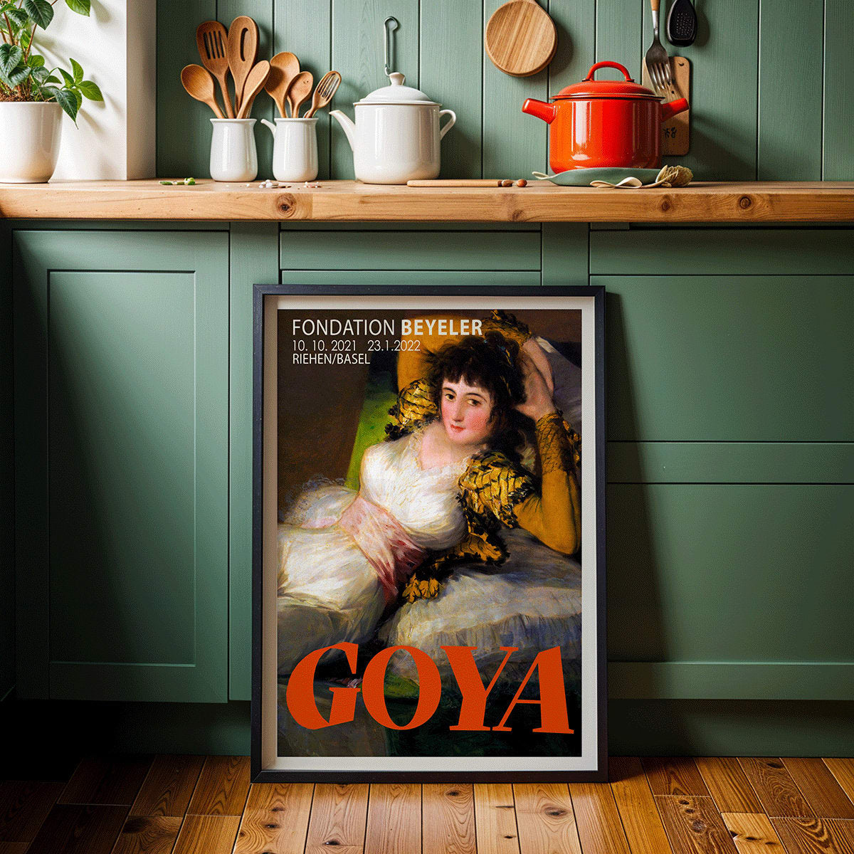 The Clothed Maja exhibition poster by Francisco Goya at Fondation Beyeler showing a reclining woman in a white and gold dress with yellow sleeves, framed and displayed in modern living room decor