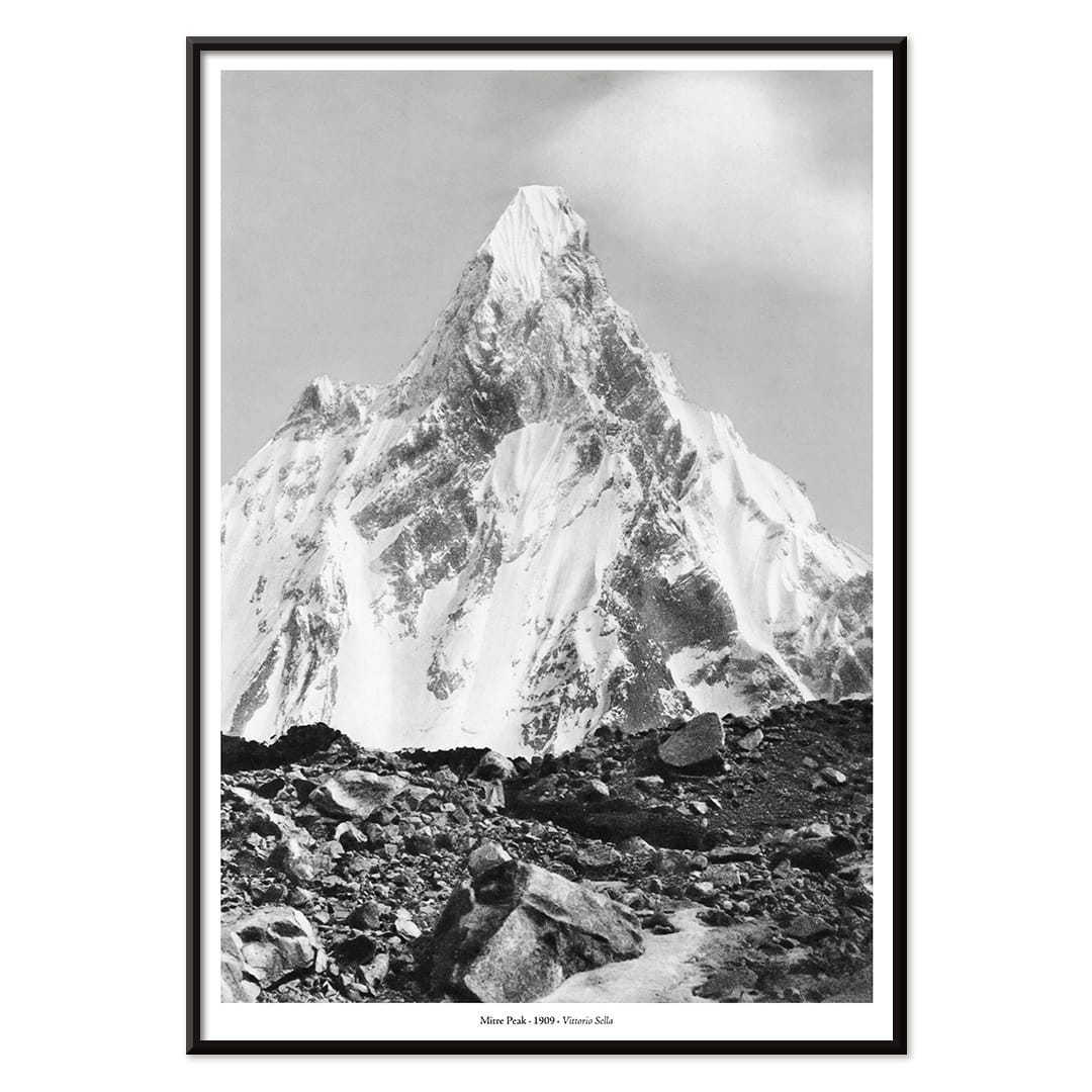 Mitre Peak surrounded by rocky terrain and snowy peak seen from Baltoro Glacier by Vittorio Sella, with black aluminium frame on white background
