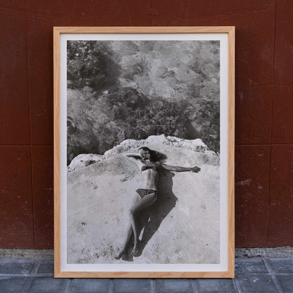 Woman in bikini lying on platform near water in Montego Bay Jamaica artwork by Nickerson Paine poster, framed and displayed in home decor