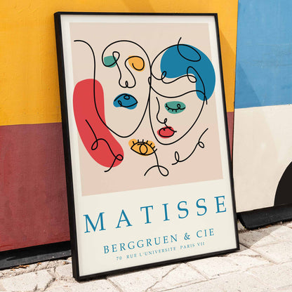 Line art portrait and poster inspired by Matisse Papiers decoupes featuring colorful abstract shapes faces in blue red and yellow with text at the bottom, framed and displayed in home decor