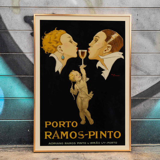 Porto Ramos-Pinto poster by Rene Vincent with two people about to kiss and a cherub holding a wine glass, framed and displayed in home decor