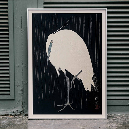 White egret standing in the rain art print poster with dark background by Ohara Koson, framed and displayed in home decor