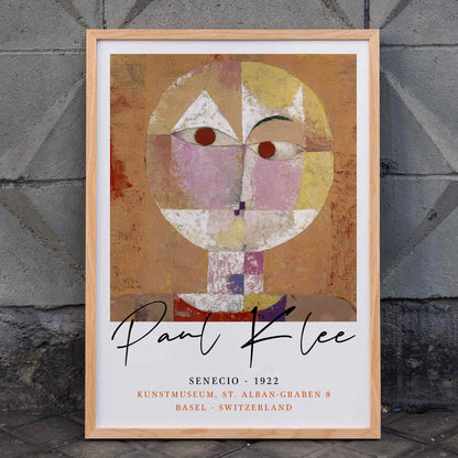 Abstract geometric portrait Senecio by Paul Klee with warm colors and geometric shapes on orange background poster, framed and displayed in home decor