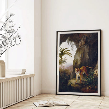 Tiger in a Cave painting by Jacques Laurent Agasse showing a tiger standing in a cave entrance surrounded by lush vegetation, framed and displayed in home decor