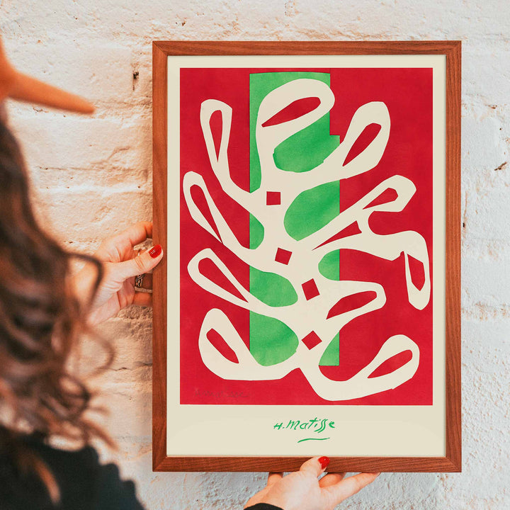 Henri Matisse White Alga on Red and Green Background poster with white seaweed cutout over red and green blocks, framed and displayed in modern living room decor