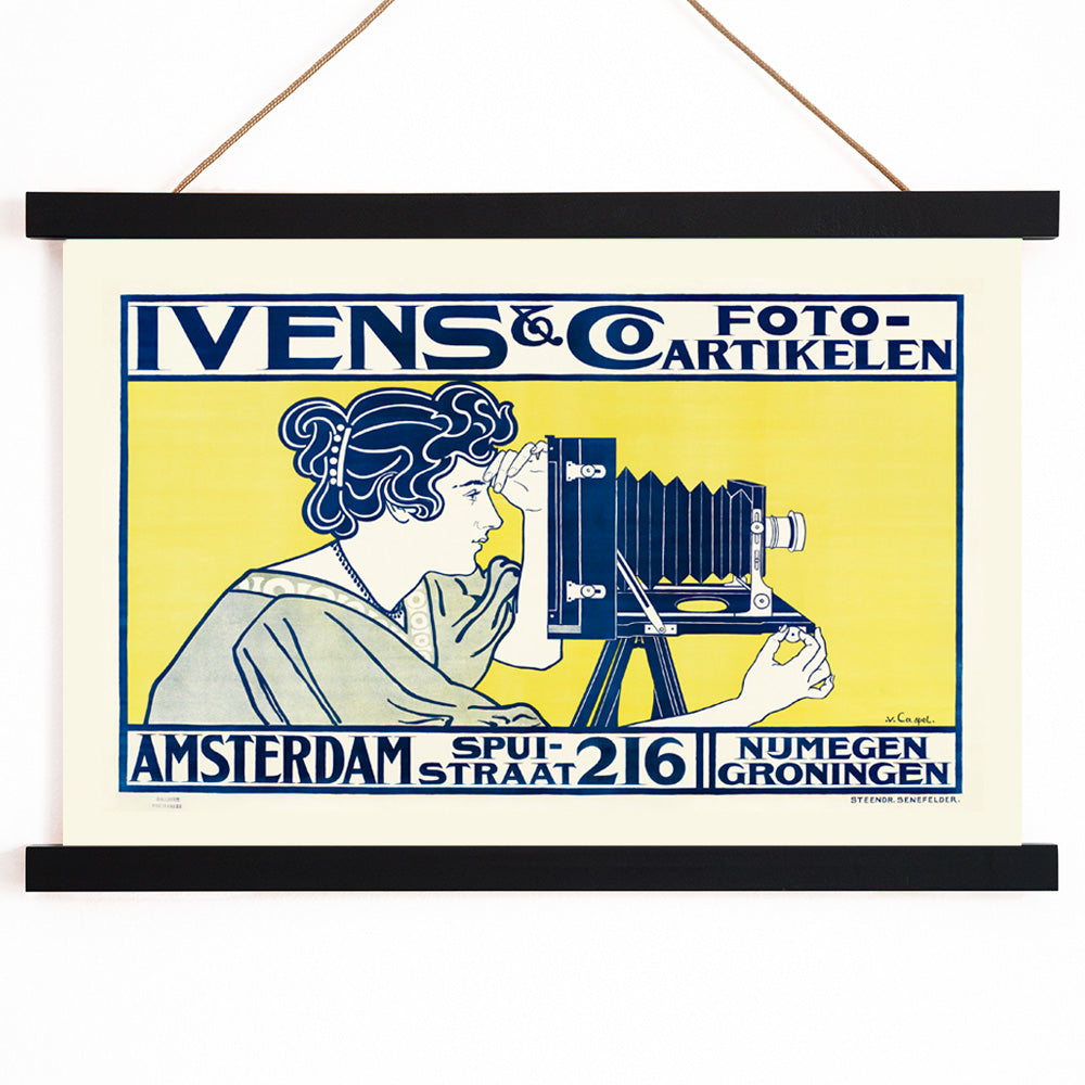 Art nouveau poster of woman using vintage camera at Ivens and Co Camera Shop by Johann Georg van Caspel, with wooden magnetic frame on white background